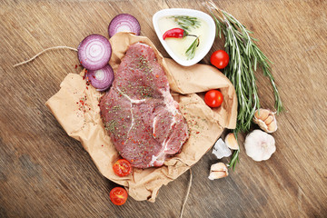 Raw beef steak on wooden table