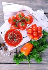 Tomato juice in goblet and fresh vegetables
