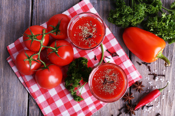 Tomato juice in glasses and fresh vegetables