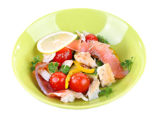 Appetizing fish salad with vegetables on plate isolated on