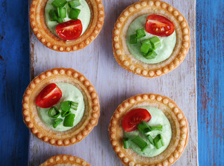 Tartlets with greens and vegetables with sauce