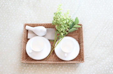 Fototapeta na wymiar Decorative tray with tea set and flower on the bed