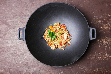 Chinese noodles with vegetables and seafood in wok