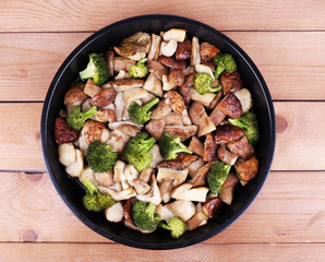 Braised wild mushrooms with vegetables and spices in pan