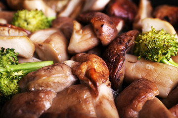 Braised wild mushrooms with vegetables and spices close-up