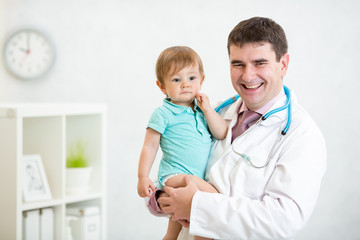 pediatrician examining heartbeat of baby with stethoscope