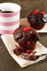 Yummy chocolate cupcake on table