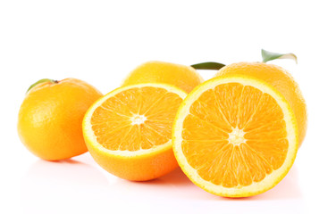 Ripe tangerines and oranges with leaves isolated on white