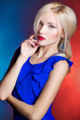 beautiful women blonde with red lips in blue dress in the Studio