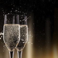 Champagne flutes on black background