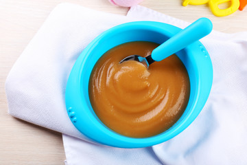 Fresh baby food in bowl with spoon
