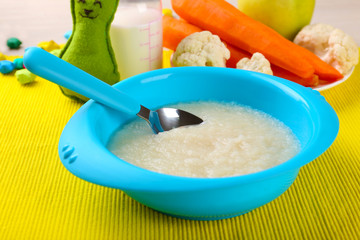 Fresh baby food in bowl with spoon