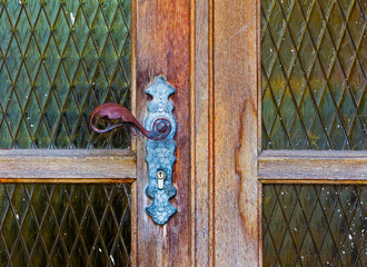 Iron door handle on old wooden door