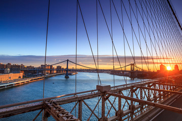 Lower Manhattan through Brooklyn Bridge at sunset, New York City