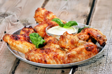 Baked chicken wings on wooden table