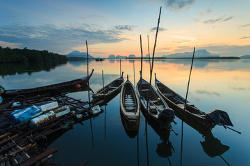 Traditional thai boats with sunrise at fisherman village