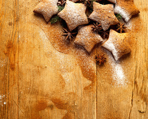 Christmas gingerbread stars on wooden background