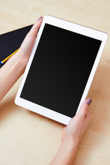 Hands holding a tablet pc with a blank screen