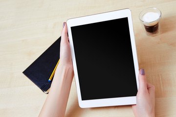 Woman holding white tablet pc in landscape mode, at work