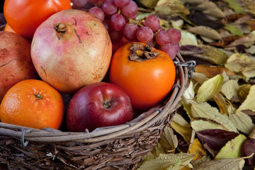 Naklejka na ściany i meble Wicker basket full of autumn fruits