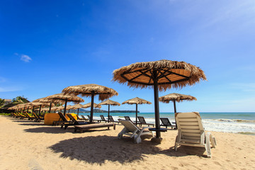 Sun umbrella and sun loungers stand at the beach in Phuket, Thai