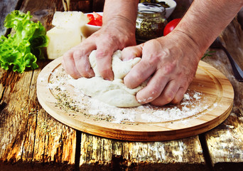 human hand knead pizza dough