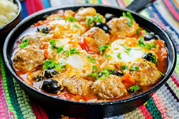 meatballs with olives and egg in tomato sauce