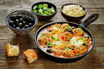 meatballs with olives and egg in tomato sauce