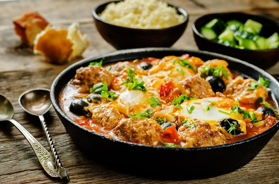 meatballs with olives and egg in tomato sauce