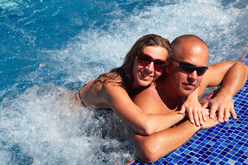 Loving couple in jacuzzi.