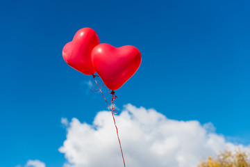 Naklejka na ściany i meble Valentine heart balloon against blue sky background