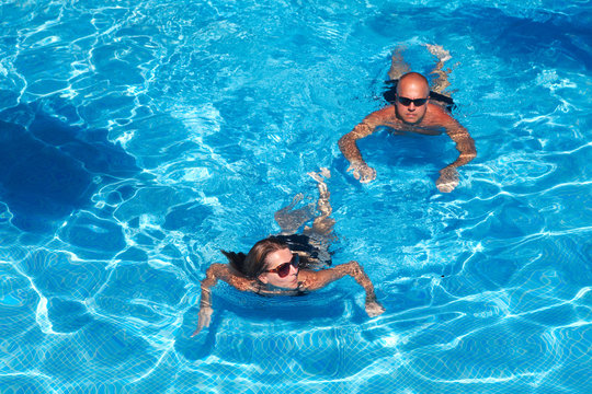 Couple swimming in pool