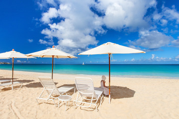 Fototapeta na wymiar Chairs and umbrellas on tropical beach