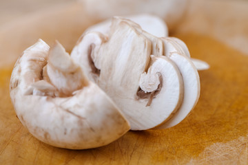 Cutting champignon on wood table