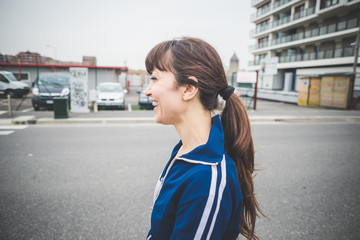 Side view of smiling young woman walking outdoors