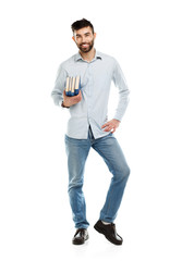Fototapeta premium Young bearded smiling man with books in hands on white