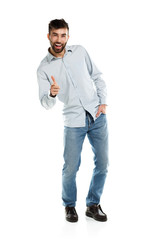 A young bearded man smiling with a finger up isolated on white