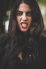 beautiful dark vampire woman with black mantle and hood