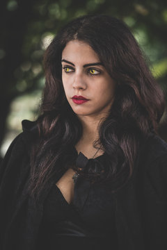 beautiful dark vampire woman with black mantle and hood