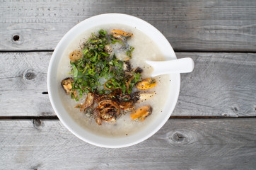 Vietnamese mussels porridge against wooden background