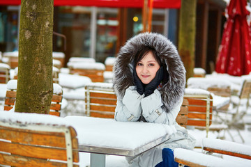 Girl enjoying rare snowy winter day in Paris