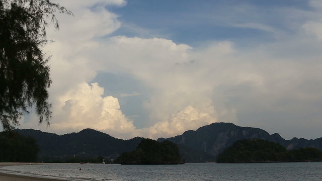 tide of the sea on the background of mountains and clouds