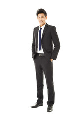 full length young smiling businessman standing