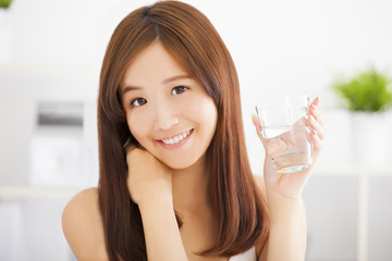 Young attractive woman drinking clean water