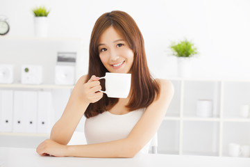 Obraz na płótnie Canvas happy asian young drinking coffee