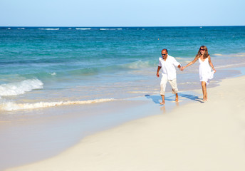 Fototapeta na wymiar Couple running on the beach
