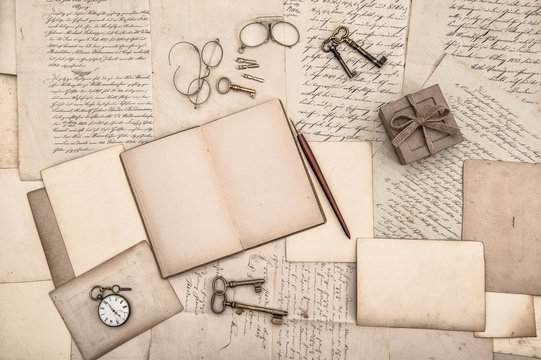 antique accessories, open book and old handwritten letters