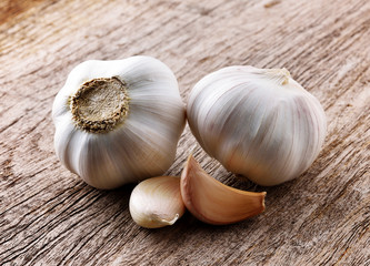 Organic garlic whole and cloves on the wooden background