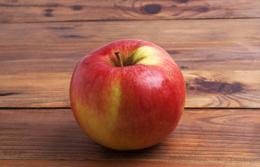 Red apple on rustic wooden background
