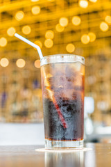 Cola glass on bokeh background